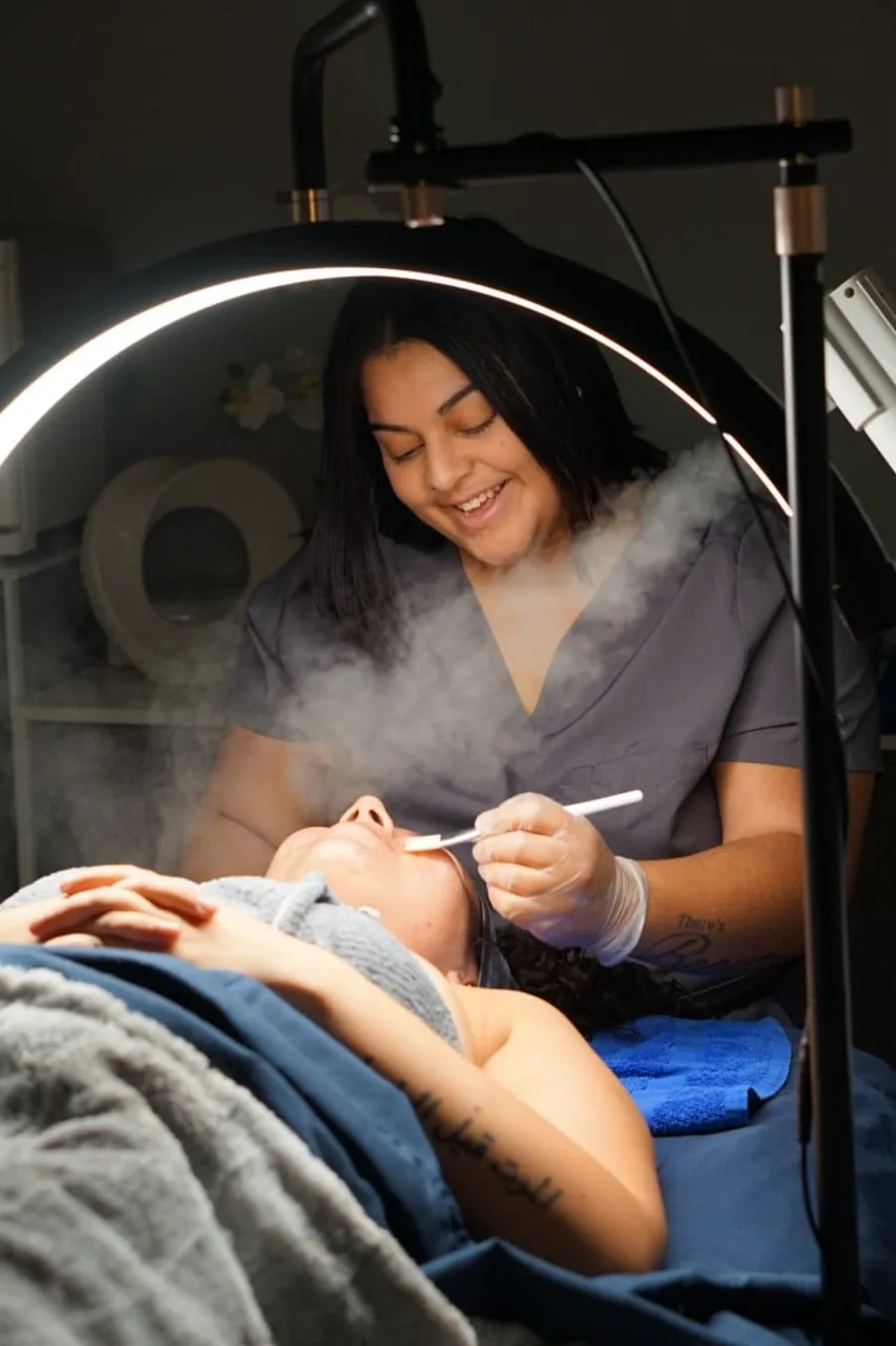 A Faciallash Lounge esthetician giving a customized facial in the Fort Myers studio
